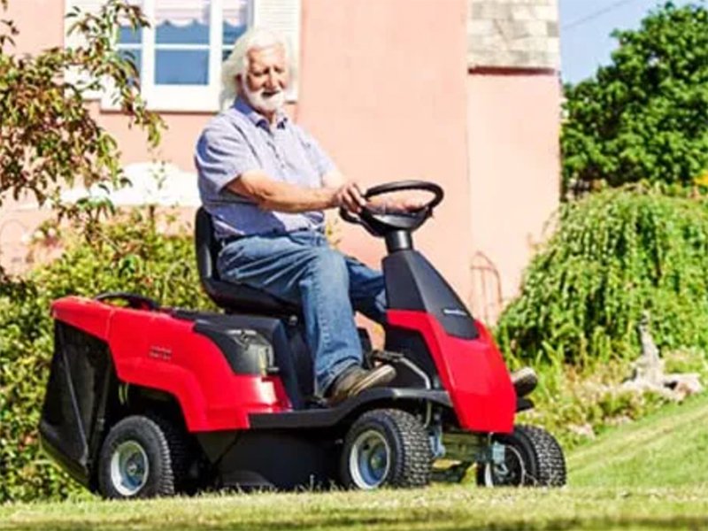 Guy on sit-on lawn mower